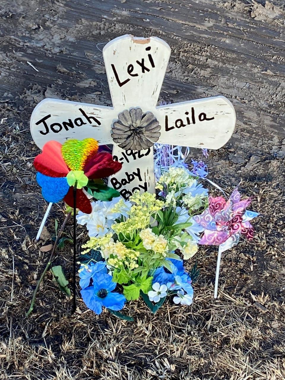 A memorial along Delaware County Road 600-W, south of Ind. 67, marks the area where three members of a Muncie family died Sunday in a traffic accident.