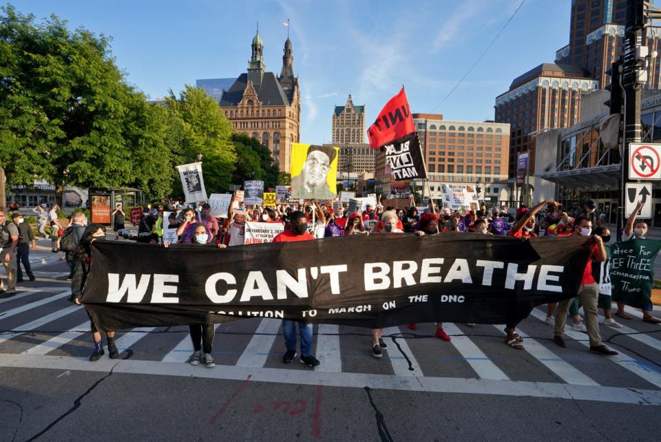 Protesters march north on Water Street in downtown Milwaukee on Thursday. The group met at Red Arrow Park during the Democratic National Convention a few blocks away at the Wisconsin Center.