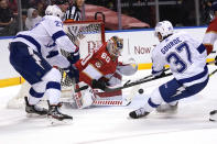 Florida Panthers goaltender Chris Driedger (60) defends against Tampa Bay Lightning defenseman Ryan McDonagh (27) and center Yanni Gourde (37) during the first period in Game 2 of an NHL hockey Stanley Cup first-round playoff series Tuesday, May 18, 2021, in Sunrise, Fla. (AP Photo/Lynne Sladky)