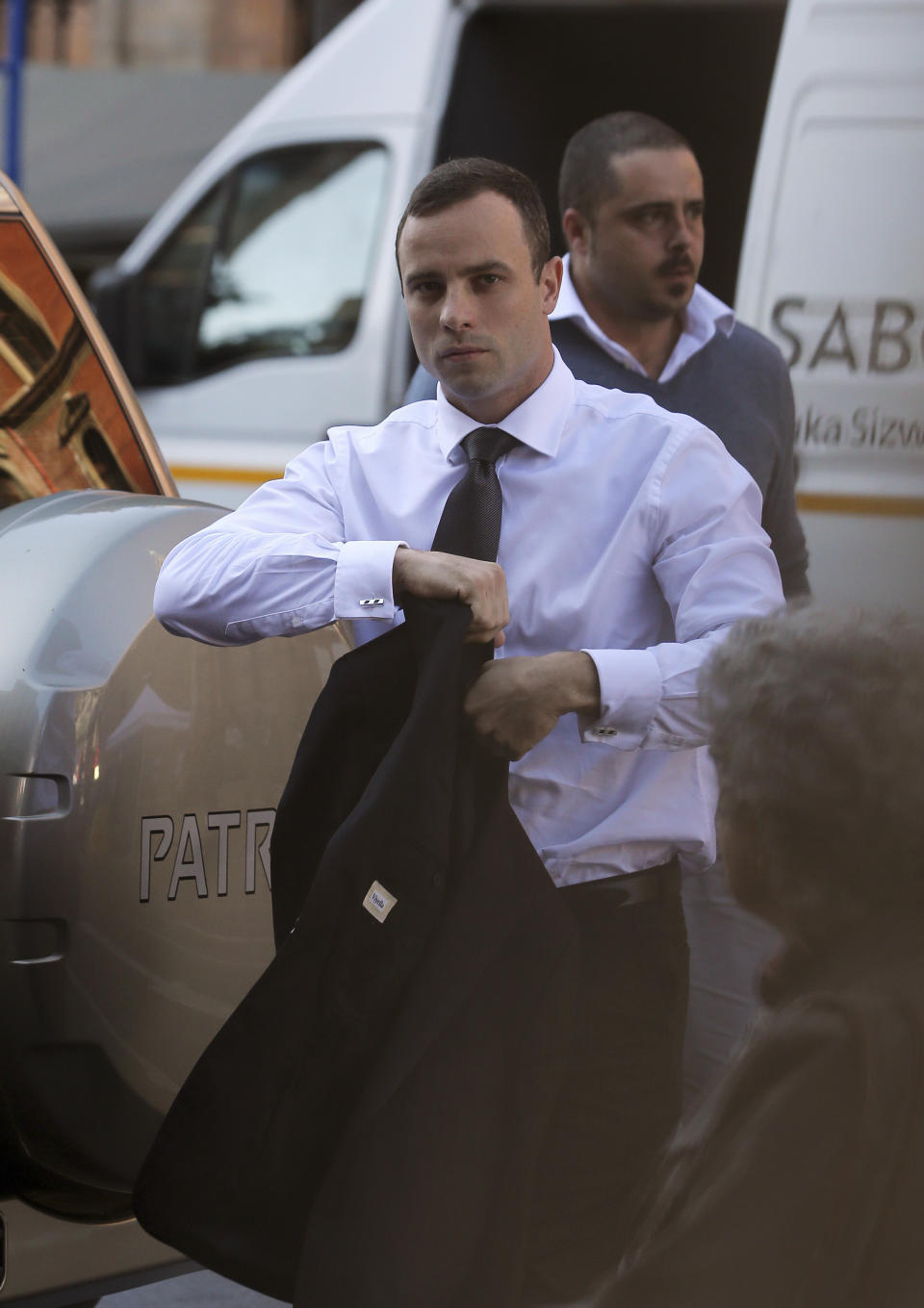 Oscar Pistorius arrives at the high court in Pretoria, South Africa, Thursday, April 10, 2014. Pistorius has resumed testifying at his murder trial and is being challenged by the chief prosecutor, who has disputed the athlete's account that he mistakenly killed his girlfriend in his home last year. (AP Photo/Themba Hadebe)