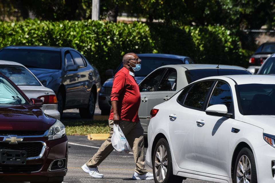 An elderly man picks up his lunch at John Knox Village, a retirement community in Pompano Beach about 40 miles north of Miami.