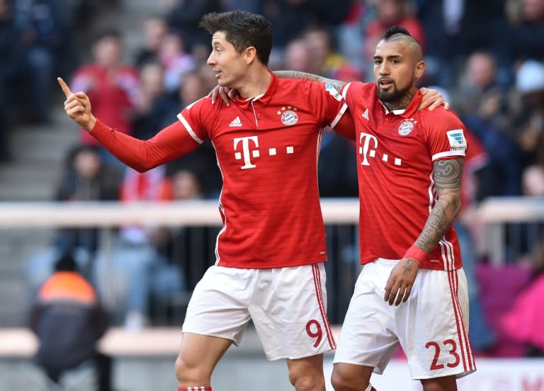 Robert Lewandowski (left) netted twice Bayern Munich went 10 points clear in the Bundesliga