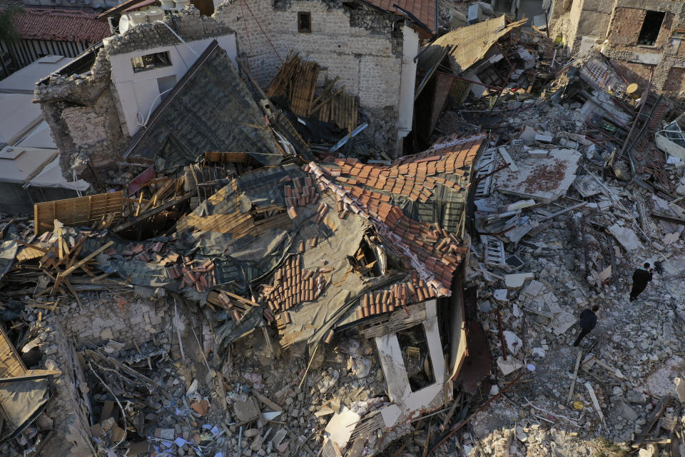 FILE - People walk on the debris of heritage houses that destroyed during the devastated earthquake, in the old city of Antakya, southern Turkey, Monday, Feb. 13, 2023. Antakya, known as Antioch in ancient times, has been destroyed many times by earthquakes. It was destroyed yet again by an earthquake earlier this month, and residents are wondering if its ancient glories will ever come back. (AP Photo/Hussein Malla, File)