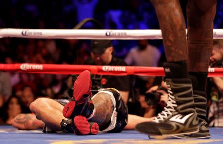 Jan 16, 2016; Brooklyn, NY, USA; Artur Szpilka lays on the mat after being knocked out by Deontay Wilder during the ninth round of their heavyweight title boxing fight at Barclays Center. Wilder defeated Szpilka via ninth round knockout. Mandatory Credit: Adam Hunger-USA TODAY Sports