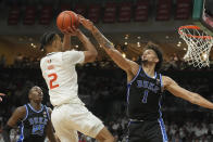 Miami guard Isaiah Wong (2) attempts to score as Duke center Dereck Lively II (1) defends during the first half of an NCAA college basketball game, Monday, Feb. 6, 2023, in Coral Gables, Fla. (AP Photo/Marta Lavandier)