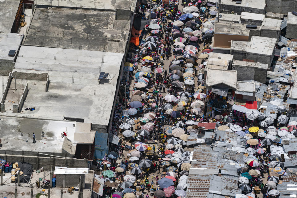 A crowded street is seen from a VM-22 Osprey on a relief mission after take off from Toussaint Louverture International Airport, Saturday, Aug. 28, 2021, in Port-au-Prince, Haiti. The VMM-266, "Fighting Griffins," from Marine Corps Air Station New River, from Jacksonville, N.C., are flying in support of Joint Task Force Haiti after a 7.2 magnitude earthquake on Aug. 22, caused heavy damage to the country. (AP Photo/Alex Brandon)