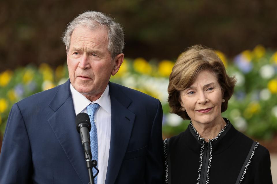 Former US President George W. Bush and First Lady Laura Bush address the media at The Billy Graham Library where they payed their respect to the late Reverend Billy Graham. LOGAN CYRUS/AFP/Getty Images