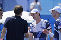 The British doubles team of Joe Salisbury, right, and Andy Murray, second from right, greet the French doubles team after defeating them during the first round of the tennis competition at the 2020 Summer Olympics, Saturday, July 24, 2021, in Tokyo, Japan. (AP Photo/Seth Wenig)