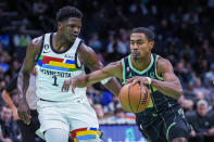 Charlotte Hornets guard Theo Maledon, right, drives around Minnesota Timberwolves guard Anthony Edwards during the first half of an NBA basketball game Friday, Nov. 25, 2022, in Charlotte, N.C. (AP Photo/Rusty Jones)