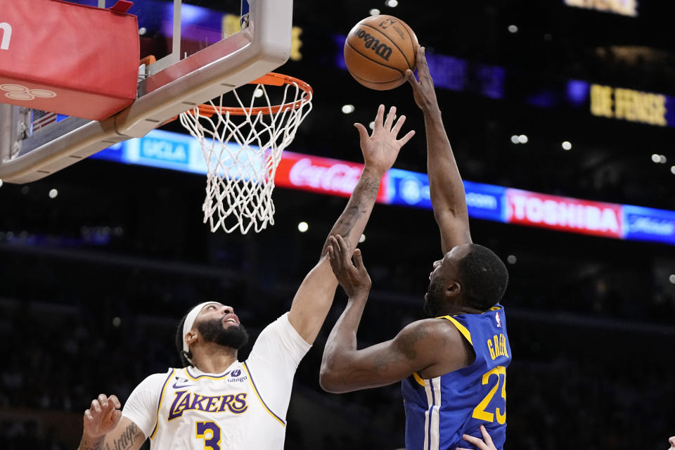 Golden State Warriors forward Draymond Green, right, shoots as Los Angeles Lakers forward Anthony Davis defends during the first half in Game 3 of an NBA basketball Western Conference semifinal Saturday, May 6, 2023, in Los Angeles. (AP Photo/Mark J. Terrill)