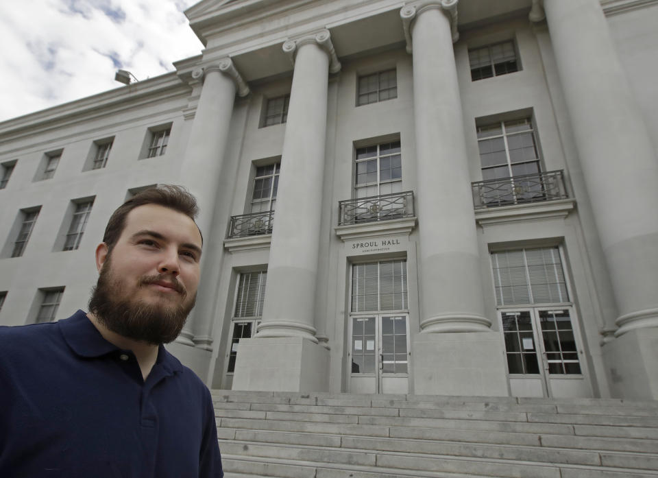University of California at Berkeley graduate Tyler Lyson stands in front of Sproul Hall on the closed Cal campus in Berkeley, Calif., on Monday, May 11, 2020. Lyson watched his parents’ financial collapse in the Great Recession, a decade ago. He vowed he’d find the security they never had: He would get a college degree. (AP Photo/Ben Margot)