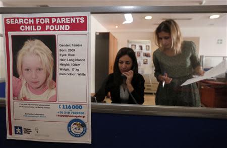 A poster of a girl, found living with a Roma couple in central Greece, is seen in the office of the "Smile of the Child" charity which is taking care of the child as police search for her biological parents, in an Athens suburb October 21, 2013. REUTERS/John Kolesidis