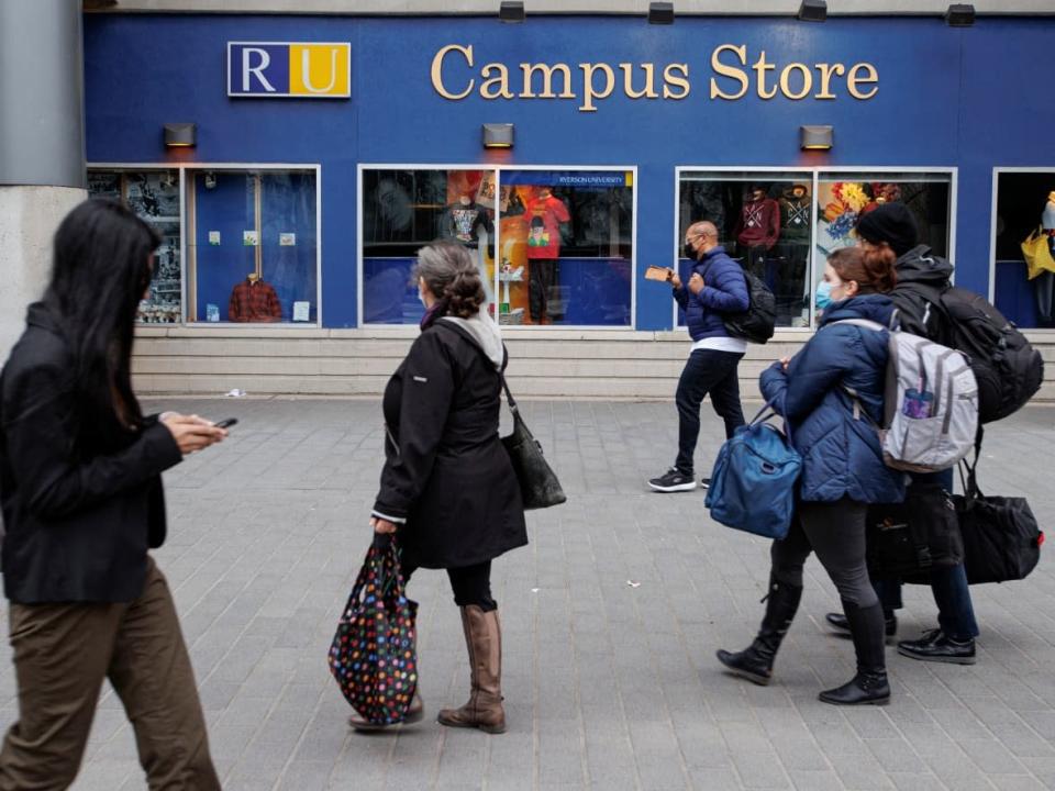 People walk through the campus of what is now Toronto Metropolitan University on Apr. 26. Though the former Ryerson University has a new name, the change will happen over phases according to its president, Mohamed Lachemi. (Evan Mitsui/CBC - image credit)