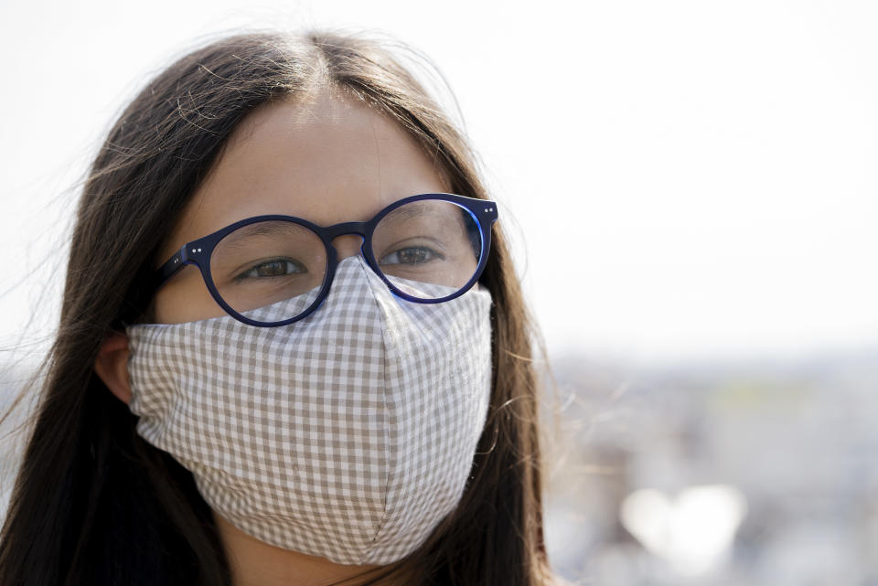 Portrait of teenage girl wearing homemade face mask to protect her health from coronavirus