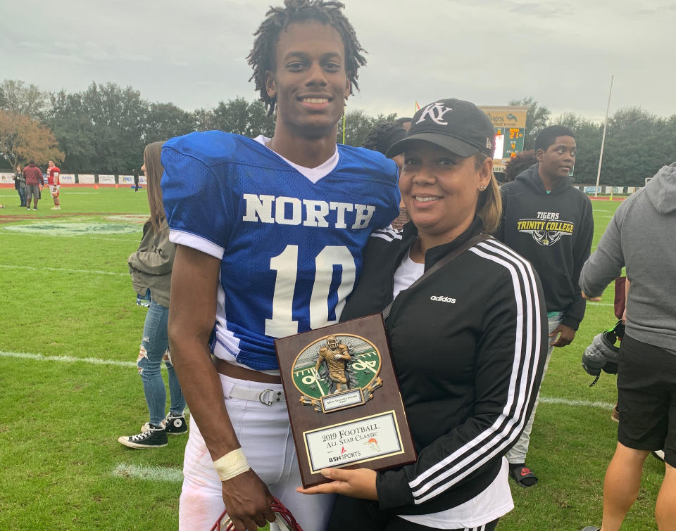 Willie Taggart Jr. and Taneshia Taggart pose for a photo after the North-South All Star game on Saturday. Willie Jr. won the North MVP award in the game. (Photo credit: Taggart family)