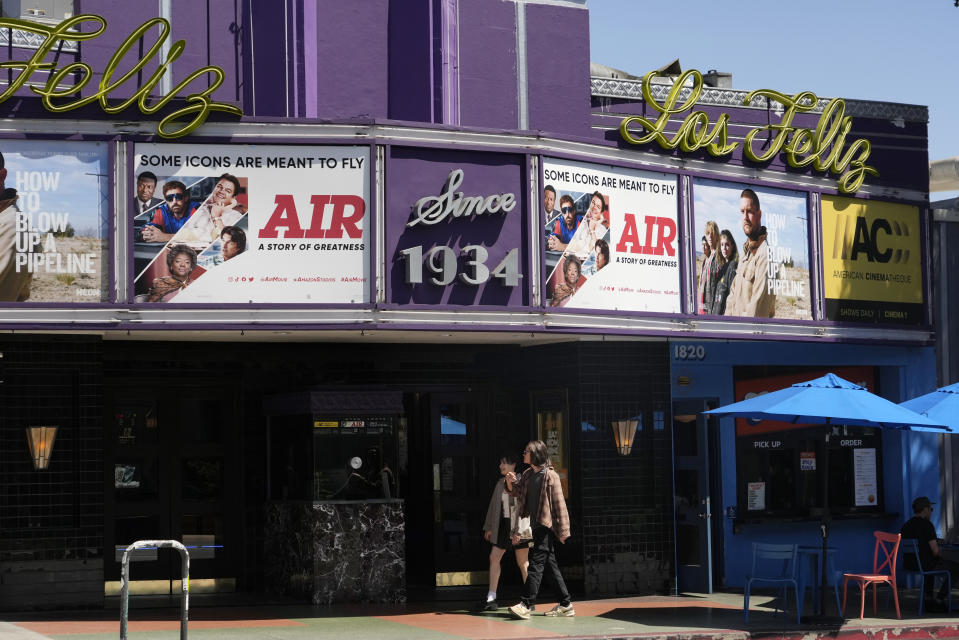 Poster art for the Amazon Studios film "Air" is displayed on the marquee of the Los Feliz Theater, Wednesday, April 19, 2023, in Los Angeles. Amazon Studios plans to release 12 to 15 movies theatrically every year, and Apple is set to spend $1 billion a year on movies that will land in cinemas before streaming. (AP Photo/Chris Pizzello)