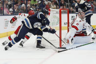 Columbus Blue Jackets' Johnny Gaudreau, left, scores against Carolina Hurricanes' Spencer Martin during the second period of an NHL hockey game Tuesday, April 16, 2024, in Columbus, Ohio. (AP Photo/Jay LaPrete)