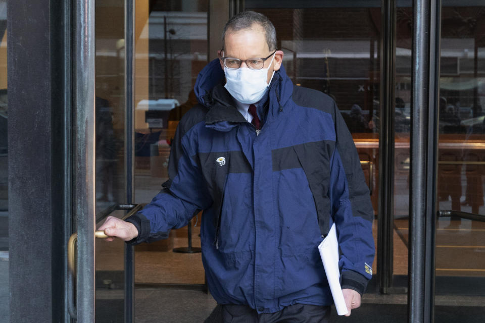 Harvard University professor Charles Lieber leaves federal court, Tuesday, Dec. 14, 2021, in Boston. Lieber is charged with hiding his ties to a Chinese-run recruitment program. His trial is the latest bellwether in the U.S. Justice Department's controversial effort to crackdown on economic espionage by China. (AP Photo/Michael Dwyer)