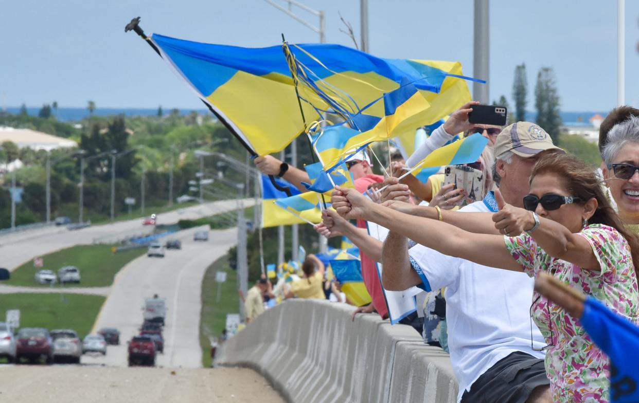 Americans show support for Ukraine at a rally earlier this month in Melbourne, Florida. Although many want to support the cause, a number of "charities" to help the people of Ukraine are actually scams.