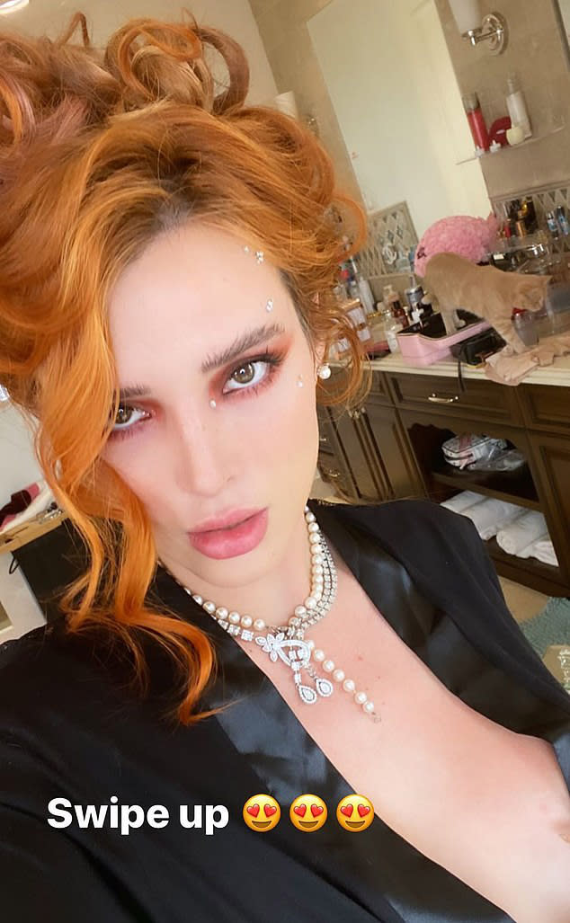 Bella Thorne poses in silk robe, slipping exposing cleavage