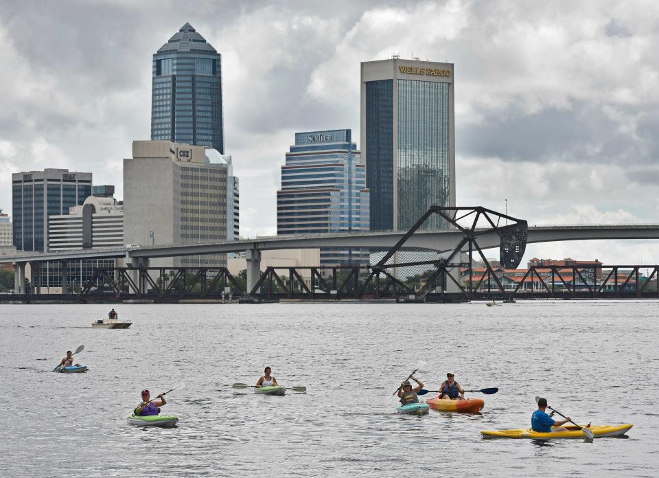 Kayakers paddle the St. Johns River through downtown Jacksonville in this file photo.