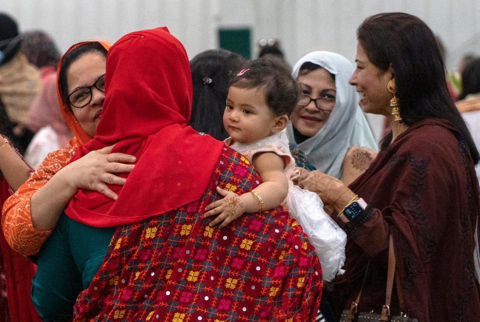 People greet each other during the Eid Al-Fitr celebration after prayers Monday, May 2, 2022 at the Grand Park Sports Complex Events Center in Westfield. Prayers started the day as the Indiana Muslim community celebrated the end of the month-long dawn-to-sunset fasting of Ramadan.