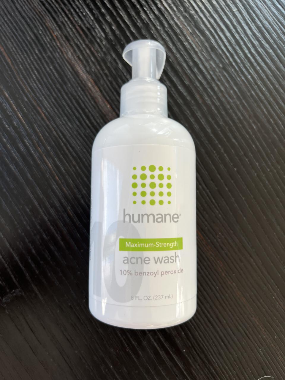 a bottle of the humane brand max strength acne wash resting on the table