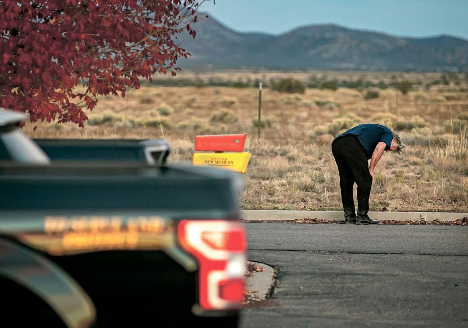 A distraught Alec Baldwin lingers in the parking lot outside the Santa Fe County Sheriff's Office in Santa Fe, N.M., after he was questioned about a shooting on the set of the film "Rust" on the outskirts of Santa Fe, Thursday, Oct. 21.
