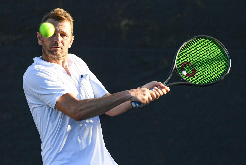 Mardy Fish looks to return the ball during an exhibition with Bob and Mike Bryan on Saturday, Jan. 15, 2022., at the Windsor Club in Indian River County. Fish paired with retired pro Thomas Blake.