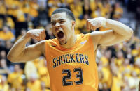 FILE - In this Feb. 22, 2014, file photo, Wichita State's Fred VanVleet flexes his muscles after making a basket against Drake during an NCAA college basketball game in Wichita, Kan. Bookmakers in Las Vegas have been watching the 31-0 Shockers win game after game this season with mounting anxiety as the NCAA tournament approaches. Although the Shockers were coming off a Final Four appearance as a No. 9 seed last spring and returned many of its players, bookmakers gave them long odds to win the national championship this year. (AP Photo/The Wichita Eagle, Travis Heying) LOCAL TV OUT; MAGS OUT; LOCAL RADIO OUT; LOCAL INTERNET OUT