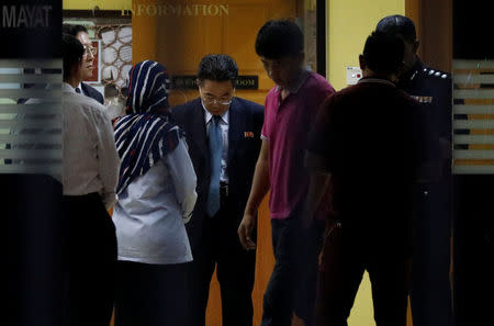 A North Korea official speaks with police and local officials at the morgue at Kuala Lumpur General Hospital where Kim Jong Nam's body is held for autopsy in Kuala Lumpur, Malaysia February 15, 2017. REUTERS/Edgar Su