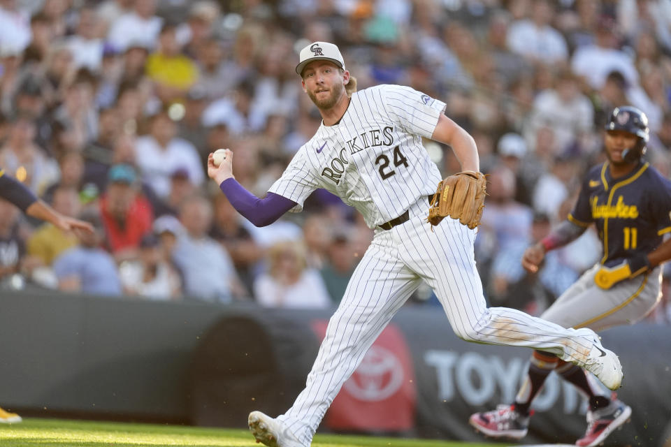 Colorado Rockies third baseman Ryan McMahon fields a single off the bat of Milwaukee Brewers' Eric Haase in the sixth inning of a baseball game Thursday, July 4, 2024, in Denver. (AP Photo/David Zalubowski)