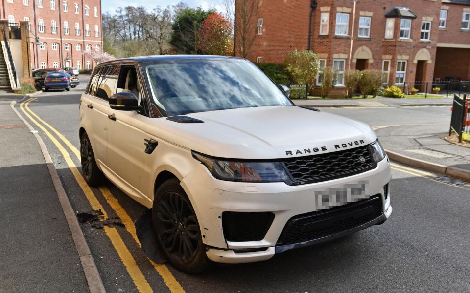 A damaged white Range Rover after reports of a crash with parked cars - PA