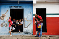 <p>A girl arrives at an improvised classroom above a state-run supermarket in La Fria, Venezuela, June 2, 2016. Education is no longer a priority for many poor and middle-class Venezuelans who are swept up in the all-consuming quest for food amid a wave of looting and riots. (Carlos Garcia Rawlins/Reuters) </p>