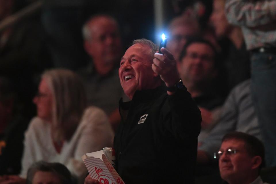 A fan waves their phone at the Eagles concert in Thompson-Boling Arena, Saturday, April 1, 2023.