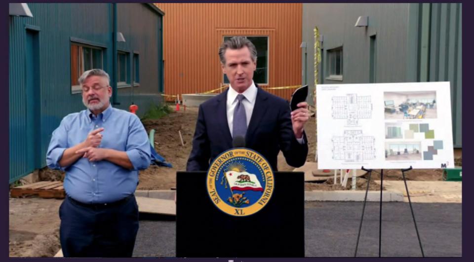 Gov. Gavin Newsom holds his face mask during a news conference in Los Angeles on Monday, Jan. 31, 2022.