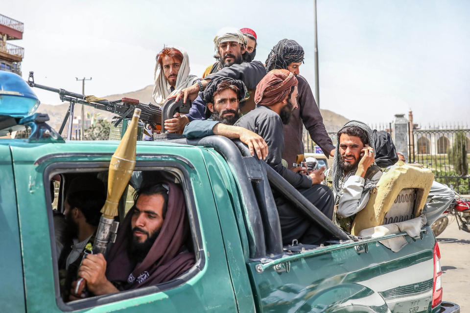 Taliban fighters are seen on the back of a vehicle in Kabul, Afghanistan, 16 August 2021. (Stringer/EPA-EFE/Shutterstock)