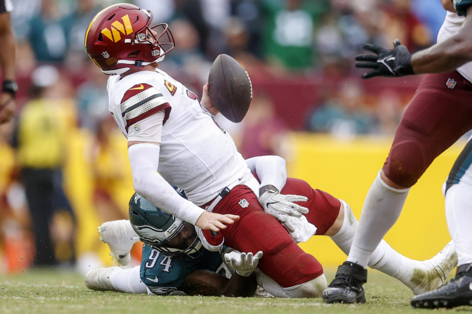 Philadelphia Eagles defensive end Josh Sweat (94) sacks Washington Commanders quarterback Carson Wentz (11) during the second half of a NFL football game between the Washington Commanders and the Philadelphia Eagles on Sunday, Sept. 25, 2022 at FedExField in Landover, Md. (Shaban Athuman/Richmond Times-Dispatch via AP)