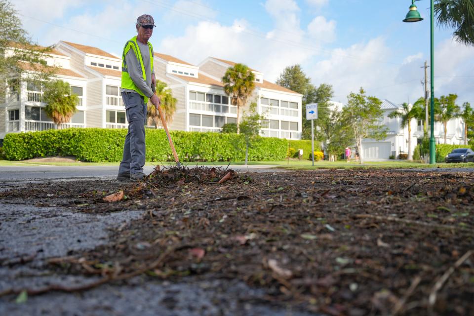 Kurt Van De Wouw of the community services department sweeps up debris from trees after Hurricane Idalia in Naples on Wednesday, Aug. 30, 2023.