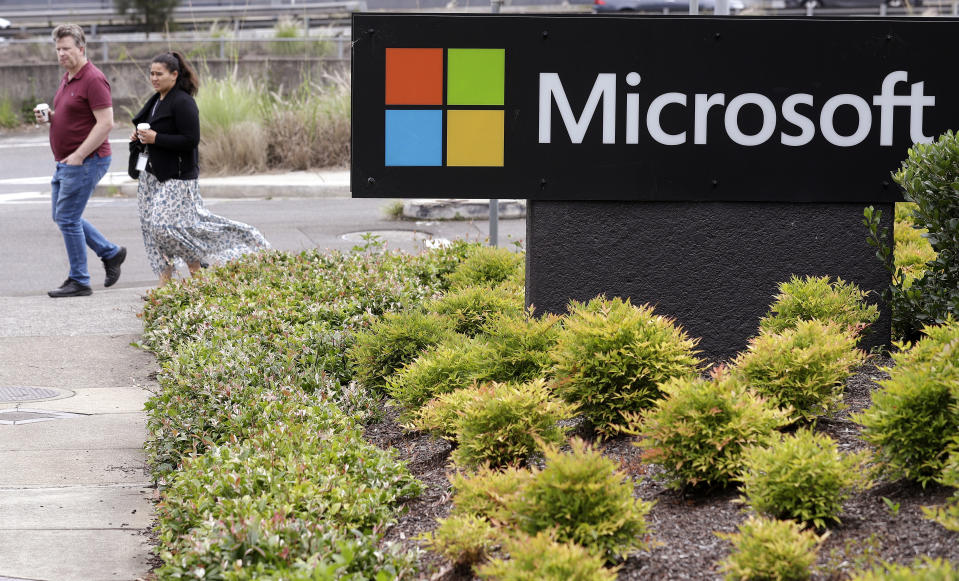 People walk past the Microsoft offices in Sydney, Wednesday, Feb. 3, 2021. Microsoft says it supports Australia's plans to make the biggest digital platforms pay for news and would help small businesses transfer their advertising to Bing if Google quits the country. (AP Photo/Rick Rycroft)