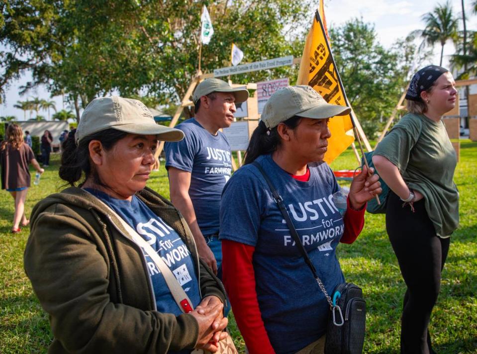 Members of the Coalition of Immokalee Workers listen to a presentation about the “Modern Slavery Museum” set up in Bryant Park, Palm Beach. The coalition’s Modern-Day Slavery Museum has displays on the history and evolution of abuse of farmworkers in the state.