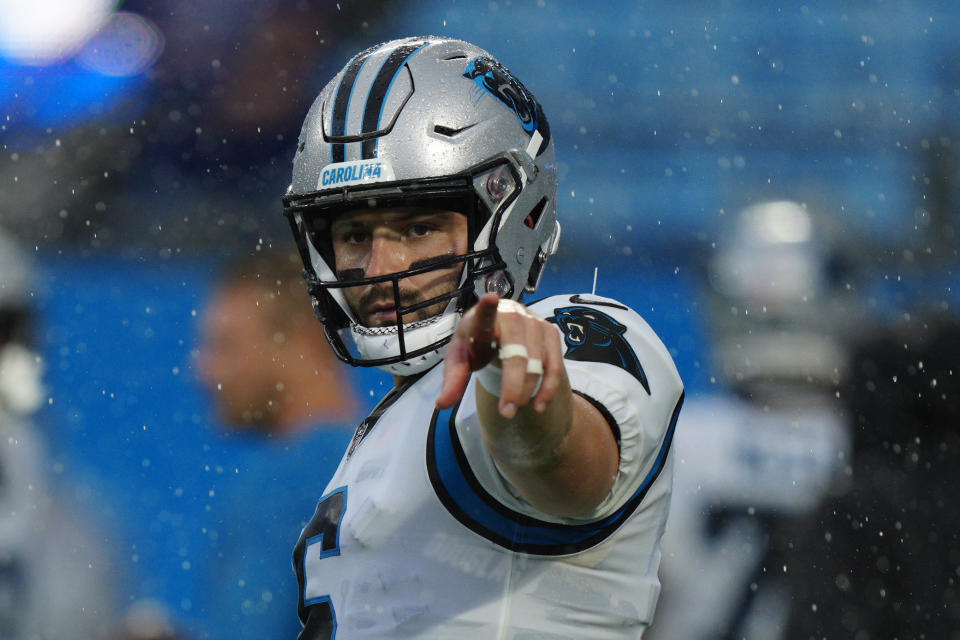 Carolina Panthers quarterback Baker Mayfield points in the rain during warms up before an NFL preseason football game against the Buffalo Bills on Friday, Aug. 26, 2022, in Charlotte, N.C. (AP Photo/Jacob Kupferman)