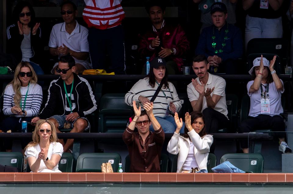 Actor Tom Holland and Actress and Singer Zendaya applaud Iga Swiatek as she's presented the championship trophy after winning the WTA final of the BNP Paribas Open in Indian Wells, Calif., Sunday, March 17, 2024.