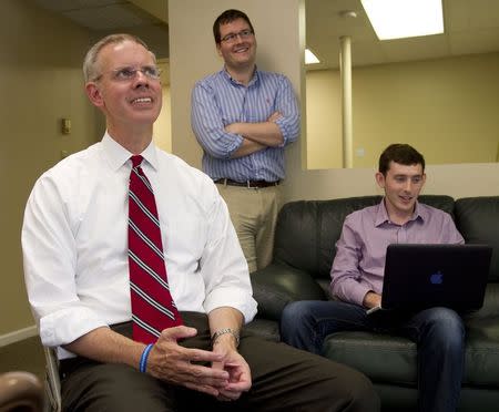 Kansas House Minority Leader and the Democratic candidate for Governor Paul Davis makes a point as he talks with his workers at his campaign headquarters in Lawrence Kansas July 24, 2014. REUTERS/Dave Kaup