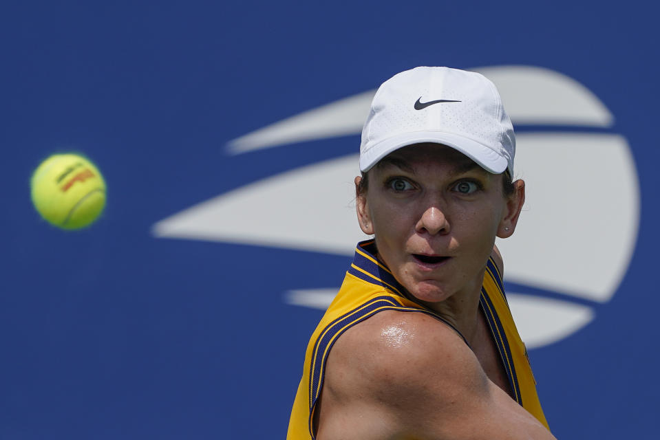 Simona Halep, of Romania, returns a shot to Camila Giorgi, of Italy, during the first round of the US Open tennis championships, Monday, Aug. 30, 2021, in New York. (AP Photo/John Minchillo)