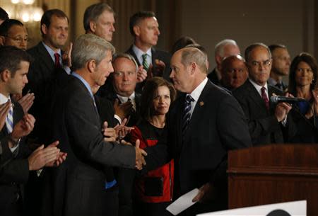 U.S. Representative Kurt Schrader (D-OR) (L) shakes hands with Representative Reid Ribble (R-WI) after both delivered remarks on behalf of No Labels, a group of Republican and Democrat Congressmen calling for a solution to end the U.S. Government shut down on Capitol Hill in Washington, October 10, 2013. REUTERS/Jason Reed