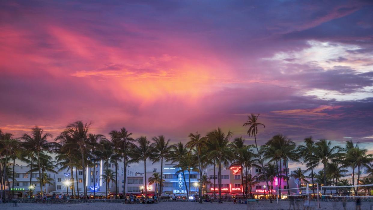 beachfront buildings under sunset sky