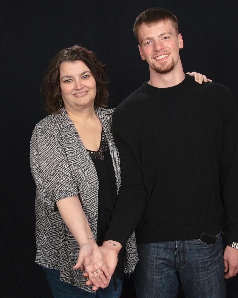 Melissa Drake and her son showing off their tattoos.