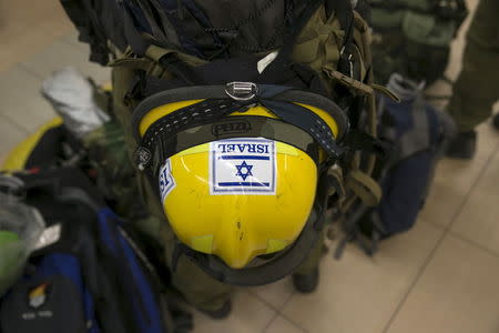 The helmet of an Israeli soldier and member of an aid delegation is seen as he waits for a flight to Nepal at Ben Gurion international airport near Tel Aviv, Israel April 26, 2015. Israel is sending to Nepal a multi-department medical facility consisting of medical staff, members of the IDF National Search and Rescue Unit and approximately 95 tons of humanitarian and medical supplies. An 7.9 magnitude earthquake struck the densely populated Kathmandu Valley on Saturday noon local time, killing more than 2,400 people and leaving tens of thousands without food, water or shelter. REUTERS/Baz Ratner