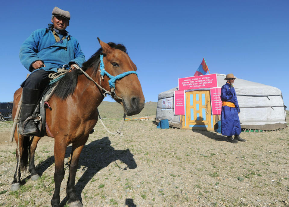 A nomad voter arrives at a yurt temporarily serving as a polling station in Hovt, western Mongolia, Thursday, June 28, 2012. Mongolians are voting for a new legislature, going to the polls by foot, car and even horse for an election centered on how best to distribute the benefits of Mongolia's mining boom. (AP Photo/Kyodo News) JAPAN OUT, MANDATORY CREDIT, NO LICENSING IN CHINA, HONG KONG, JAPAN, SOUTH KOREA AND FRANCE